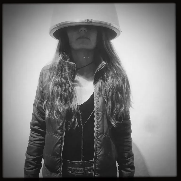 Black and white portrait of Nicholette Jean wearing a lampshade over her head